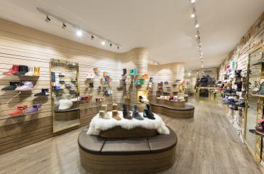 a shoe store with many shoes on display