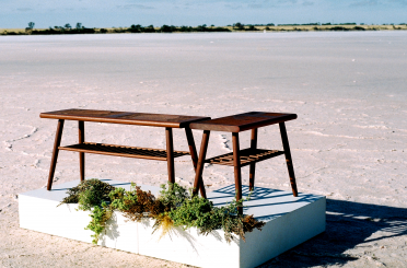 a bench and table on a white square box