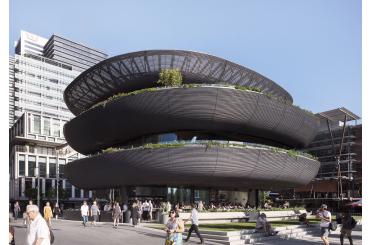 a building with a circular structure with people walking around