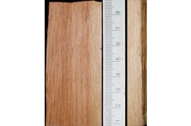 a white ruler on a wood surface