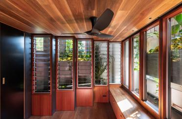 a room with wood walls and windows