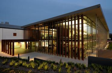 a building with glass walls and a walkway