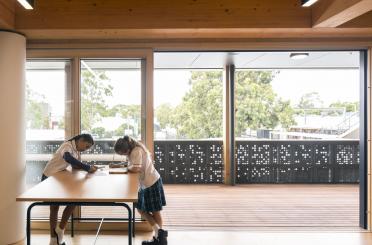 two girls writing on a table