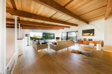 a living room with wood beams and a couch