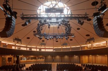 a large round auditorium with chairs and a large round ceiling