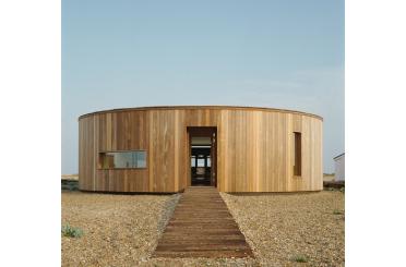 a circular building with a walkway leading to it