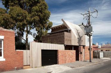 a house with a garage and a tree