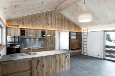 a kitchen with wood paneling