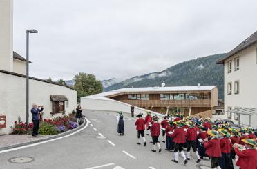 a group of people in red uniforms walking down a street