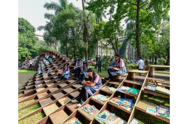 a group of people sitting on stairs with books on them